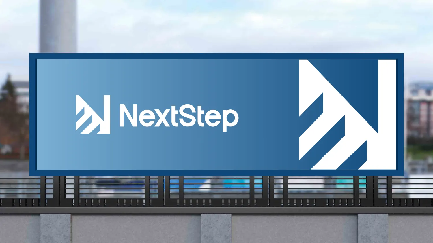 A roadside billboard mockup with the NextStep logo on a blue gradient panel and the stepped N enlarged to fill the right-hand side